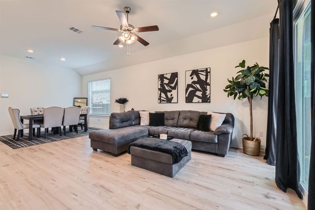 Living room featuring light wood-type flooring, visible vents, recessed lighting, and ceiling fan | Image 7