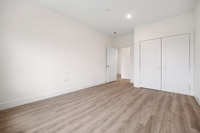 Unfurnished bedroom featuring light wood finished floors, a closet, baseboards, and recessed lighting | Image 19