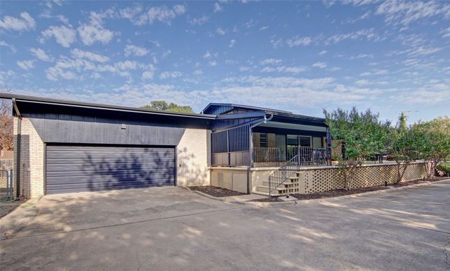 Oversized garage features automatic roll up doors on both sides for complete drive through around the house. | Image 31
