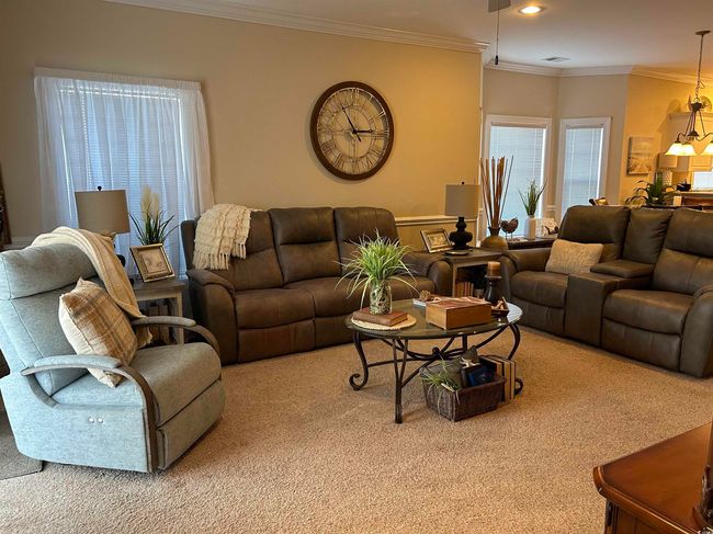 Carpeted living room with ornamental molding, visible vents, and recessed lighting | Image 7