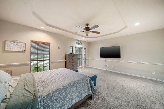 Bedroom featuring a tray ceiling, carpet, a ceiling fan, baseboards, and recessed lighting | Image 19
