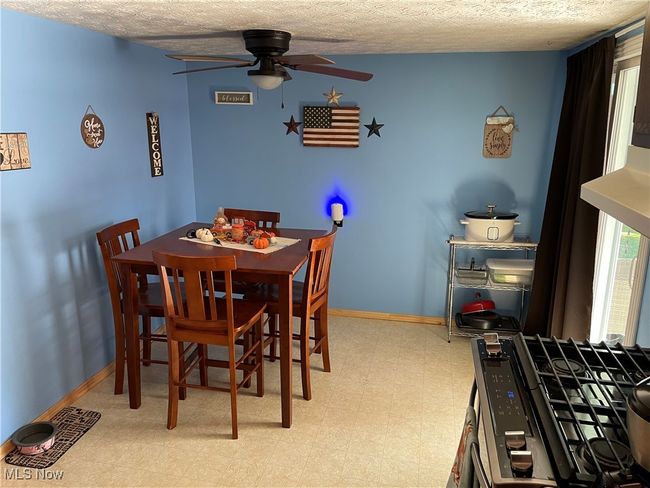 Dining room with a textured ceiling and ceiling fan | Image 8