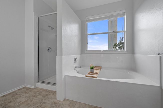 Bathroom featuring a shower stall, a bath, and tile patterned floors | Image 19