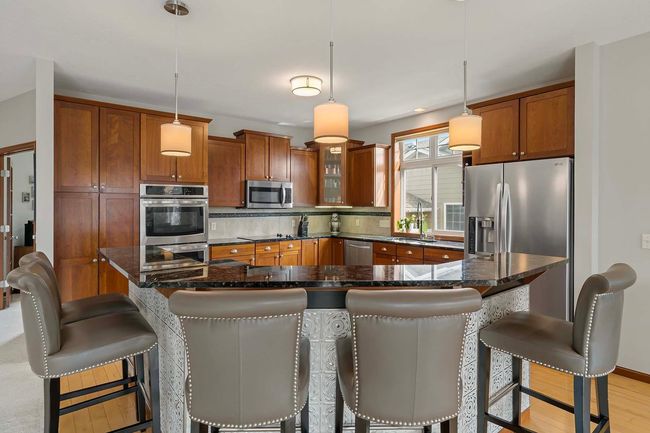 Great for entertaining, the bar-height counter has room for five chairs! | Image 7