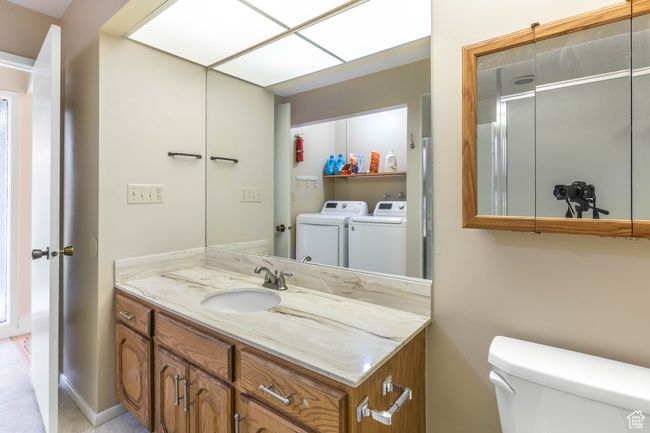 Bathroom with independent washer and dryer, toilet, and vanity | Image 23