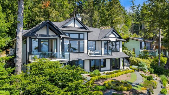 Rear view of property featuring roof with shingles, a chimney, and a patio area | Image 17
