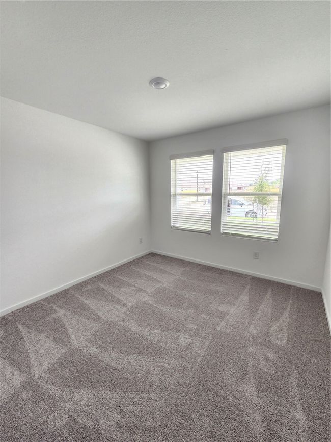 Carpeted spare room featuring healthy amount of natural light | Image 8