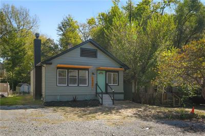 Bungalow-style house featuring a storage unit | Image 2