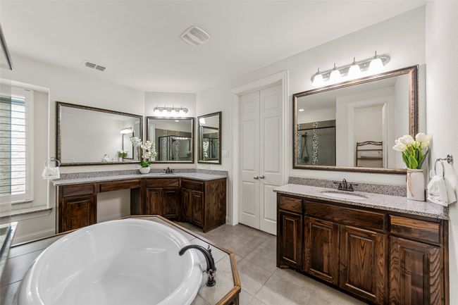 Bathroom featuring two vanities, a bath, tile patterned floors, and a closet | Image 22