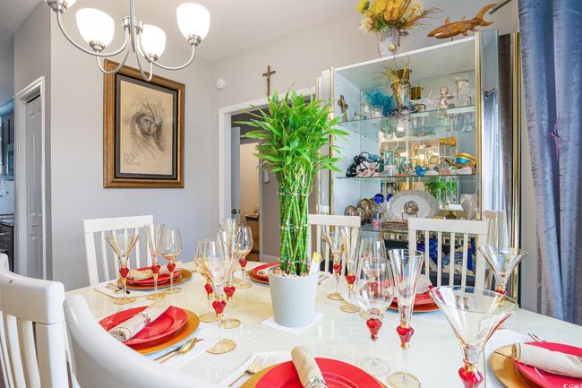 Dining area with a chandelier | Image 7