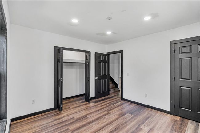 bedroom featuring wood finished floors, baseboards, a closet, and recessed lighting | Image 35