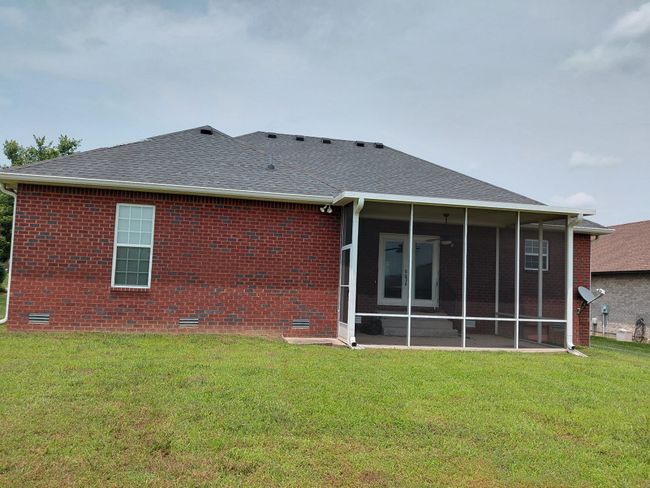 All brick home with screened in back porch and level backyard. | Image 11