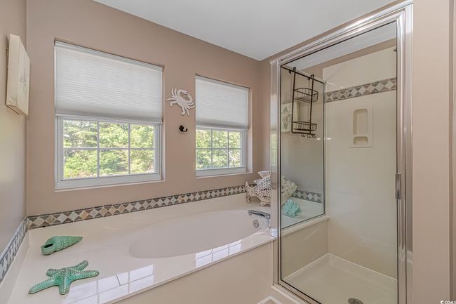 Bathroom with a shower stall and a bath | Image 27