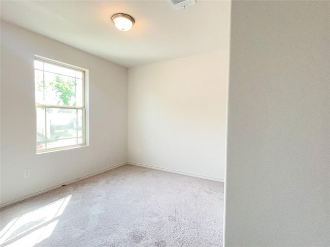 Bright upstairs third bedroom with cozy carpeting. | Image 11
