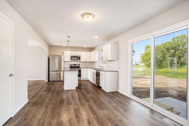 There is a dedicated dining nook adjacent to the kitchen. Sliding doors lead to the rear yard which has a 10x10 patio – perfect for indoor/outdoor dining & entertaining. | Image 5