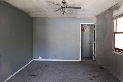 Unfurnished room with ceiling fan, a textured ceiling, and carpet floors | Image 2