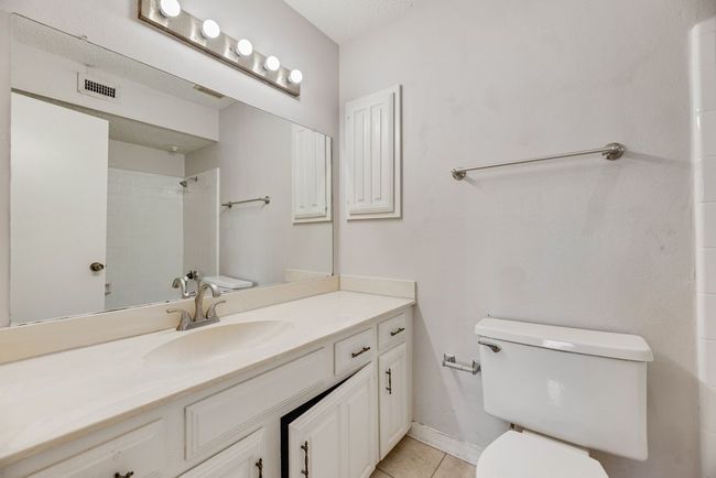 Full bath featuring vanity, tile patterned floors, and a shower | Image 13