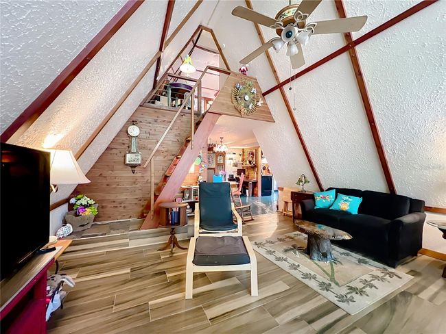 View from the front doorway. Note the paddle steps to the loft above. The loft has 2 rooms and a 1/2 bath. | Image 10