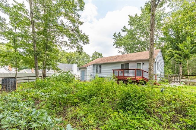 Back of property with a wooden deck | Image 33