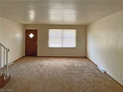 Foyer entrance with carpet floors | Image 3