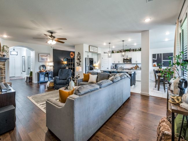 Living room featuring arched walkways, dark wood-style flooring, baseboards, recessed lighting, and a ceiling fan | Image 13