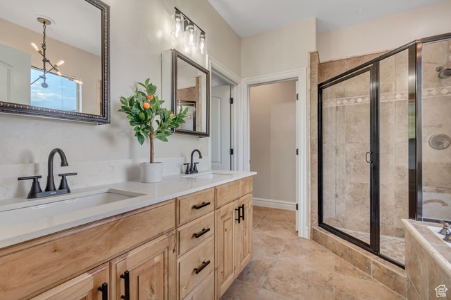 Bathroom featuring double vanity, a shower stall, and a chandelier | Image 17