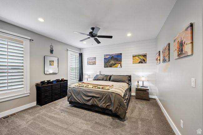 Bedroom featuring recessed lighting, baseboards, carpet flooring, a ceiling fan, and wooden walls | Image 29