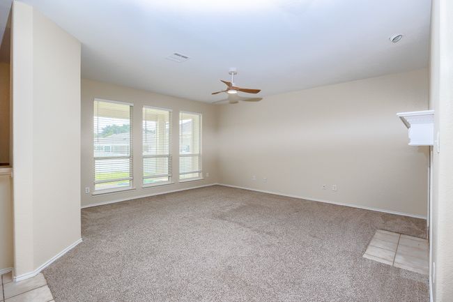 Second living room with ceiling fan and light colored carpet | Image 9