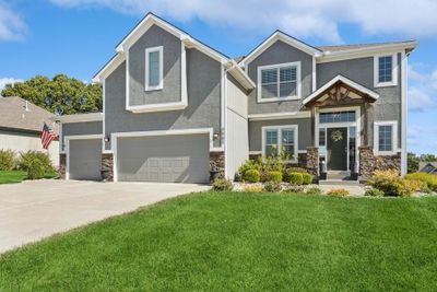 Craftsman inspired home featuring a garage and a front lawn | Image 1