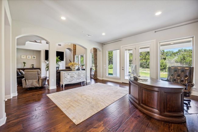 Office with recessed lighting, baseboards, dark wood finished floors, arched walkways, and visible vents | Image 9