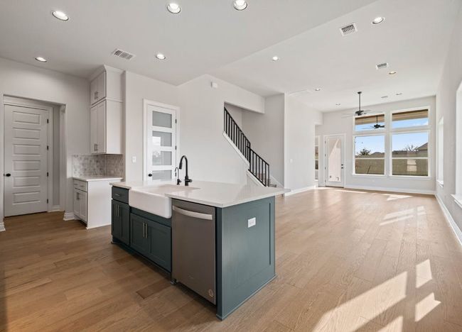 Kitchen featuring visible vents, stainless steel dishwasher, recessed lighting, and a sink | Image 12
