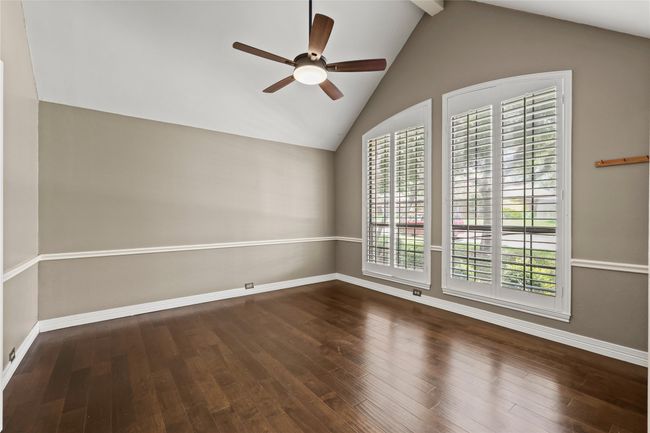 Spare room featuring ceiling fan, lofted ceiling, and wood-type flooring | Image 8