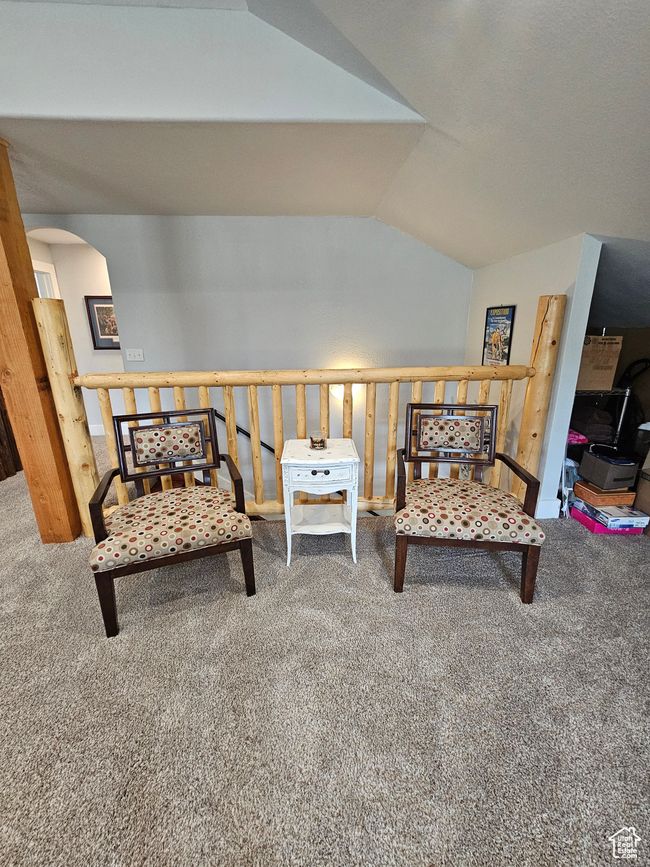 Living area featuring arched walkways, lofted ceiling, and carpet | Image 50