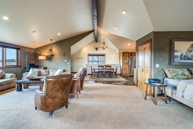 Caretaker Quarters / Guest House. Living area featuring recessed lighting, lofted ceiling with beams, an inviting chandelier, and carpet floors | Image 75
