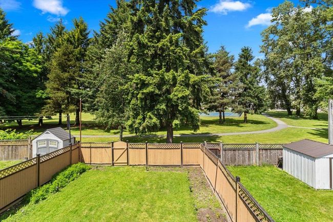 View of yard with a gate, an outbuilding, a fenced backyard, and a shed | Image 35