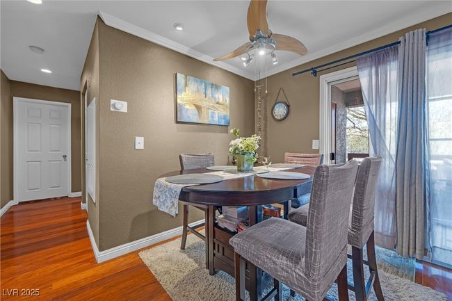 Dining space with a ceiling fan, crown molding, baseboards, and wood finished floors | Image 14