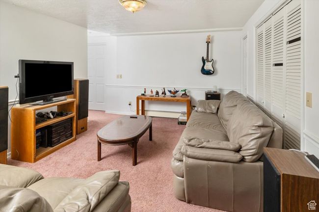 Family room featuring a textured ceiling and carpet flooring | Image 29