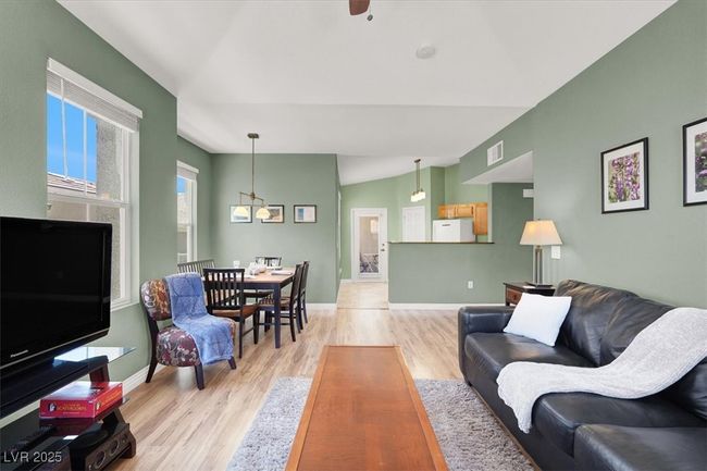 Living room with baseboards, visible vents, and light wood-style floors | Image 11