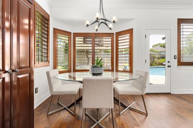 Dining area featuring a chandelier, dark wood finished floors, and ornamental molding | Image 13