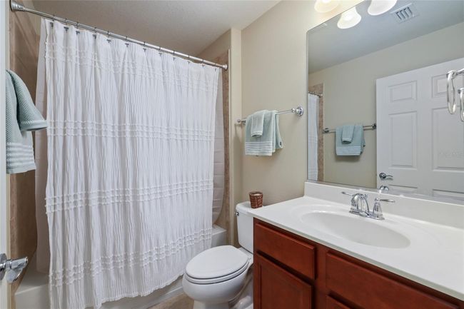 Well-appointed guest bathroom conveniently located near secondary bedrooms and living areas. | Image 16