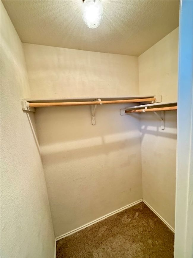 Spacious closet with dark colored carpet | Image 24
