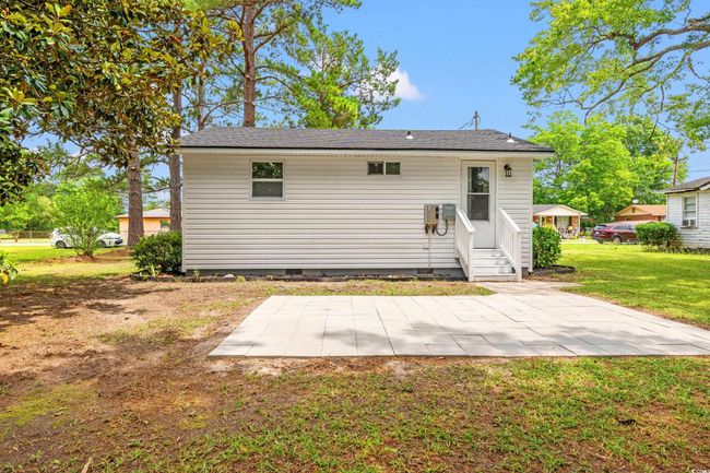 Back of property with crawl space, a lawn, a patio area, and entry steps | Image 15