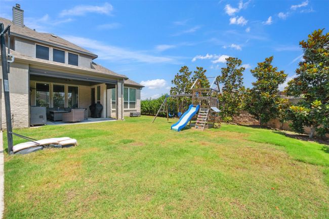 Fenced backyard featuring outdoor lounge area, a playground, and a patio | Image 37