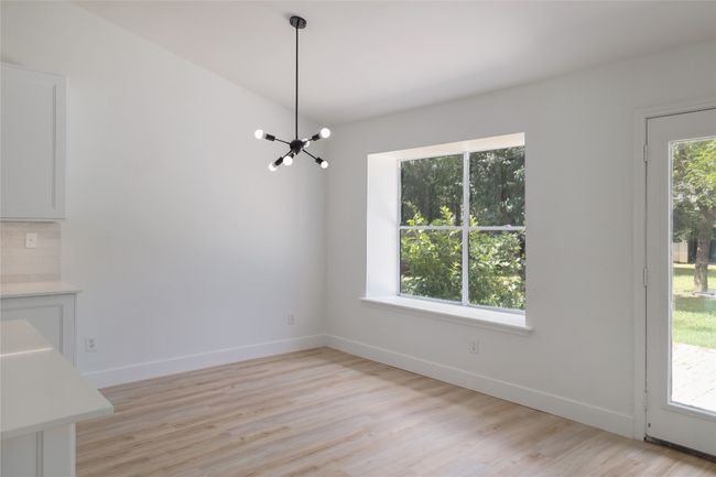 The breakfast nook charms with a view and natural light from the backyard. | Image 13