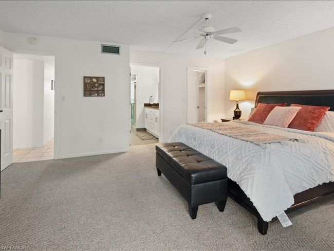 Spacious bedroom and connected bathroom, light carpet | Image 7