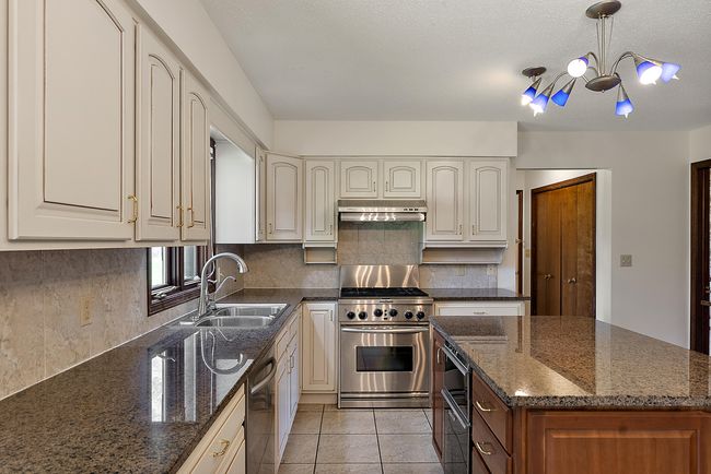 Kitchen with stainless steel appliances and gas range. | Image 9