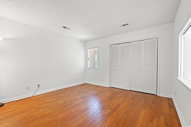 Unfurnished bedroom featuring wood finished floors and a closet | Image 23