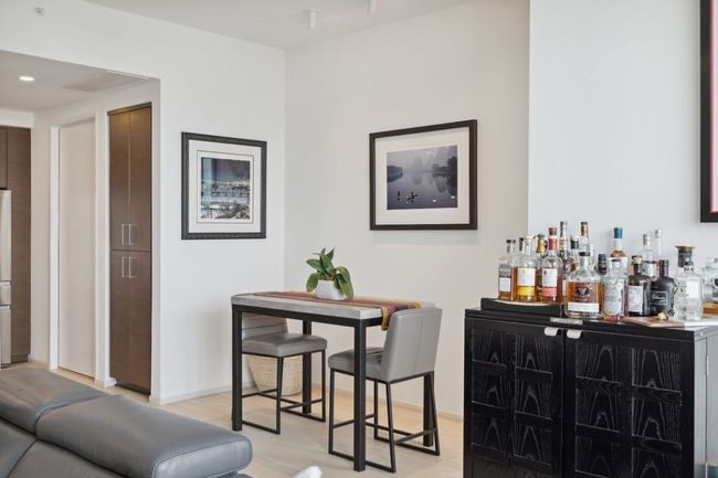 Indoor dry bar featuring light wood-type flooring, baseboards, and freestanding refrigerator | Image 19
