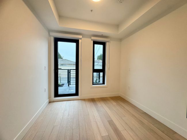 Unfurnished room with a raised ceiling, light wood finished floors, and baseboards | Image 33