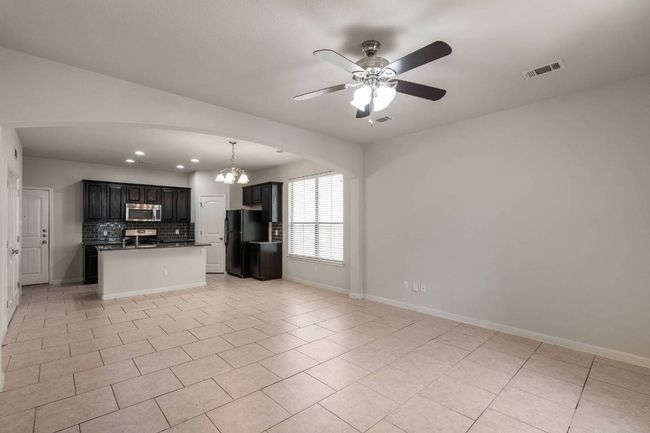 This thoughtfully designed home features an open and airy floorplan, high ceilings, and lots of windows that fill the space with natural light. | Image 10